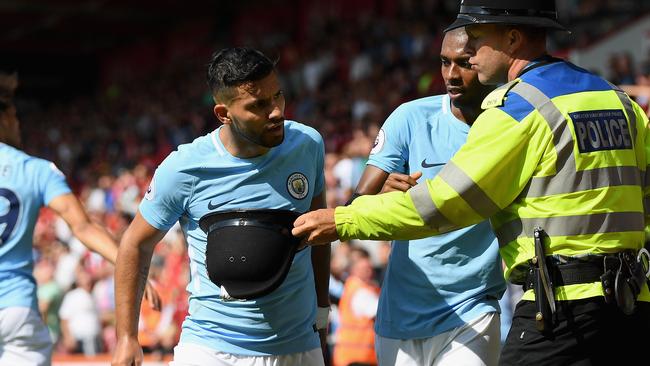 Sergio Aguero of Manchester City argues with a police man.