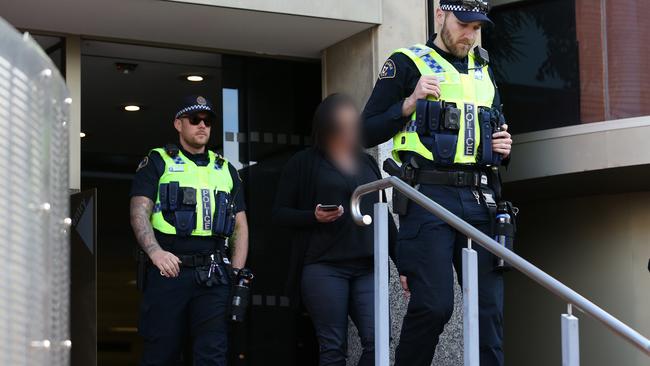 Melissa Oates leaves Hobart Magistrates Court under police escort  after her court hearing   following Huonville road death of boyfriend Jari Wise was adjourned.  Picture: Zak Simmonds