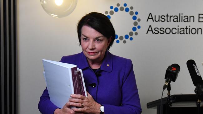 Australian Banking Association CEO Anna Bligh leaves a press conference in Sydney holding a copy of the banking royal commission’s interim report.  Picture: AAP