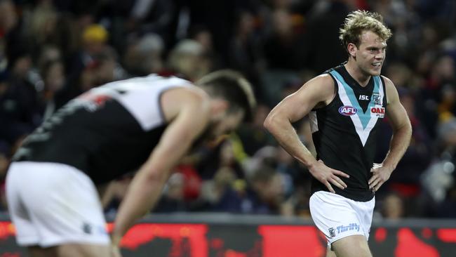 Port Adelaide’s Charlie Dixon and Jack Watt react to a Crows goal in Showdown 45. Picture SARAH REED