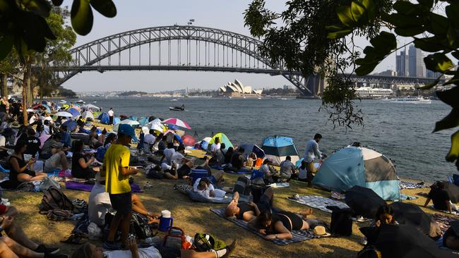 Revellers at Blues Point Reserve ahead of the Year's Eve celebrations in Sydney in 2019. Picture: AAP/ Lukas Coch