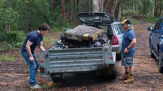 Volunteers from the Coffs Harbour Mountain Bike Club clear rubbish from Pine Creek State Forest.