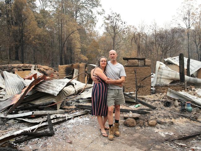 Tracey Davis and Kevin Cavanagh standing in the ruins of their home. Picture: Peter Lorimer