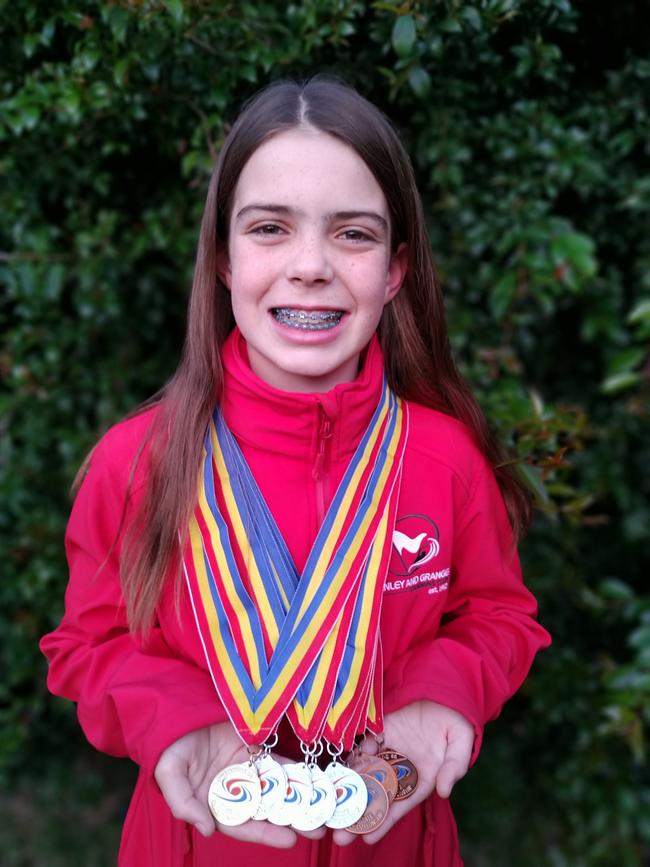 Henley and Grange swimmer Isabella Beaumont shows off her medal haul from the SA Short Course Championships. Picture: Supplied