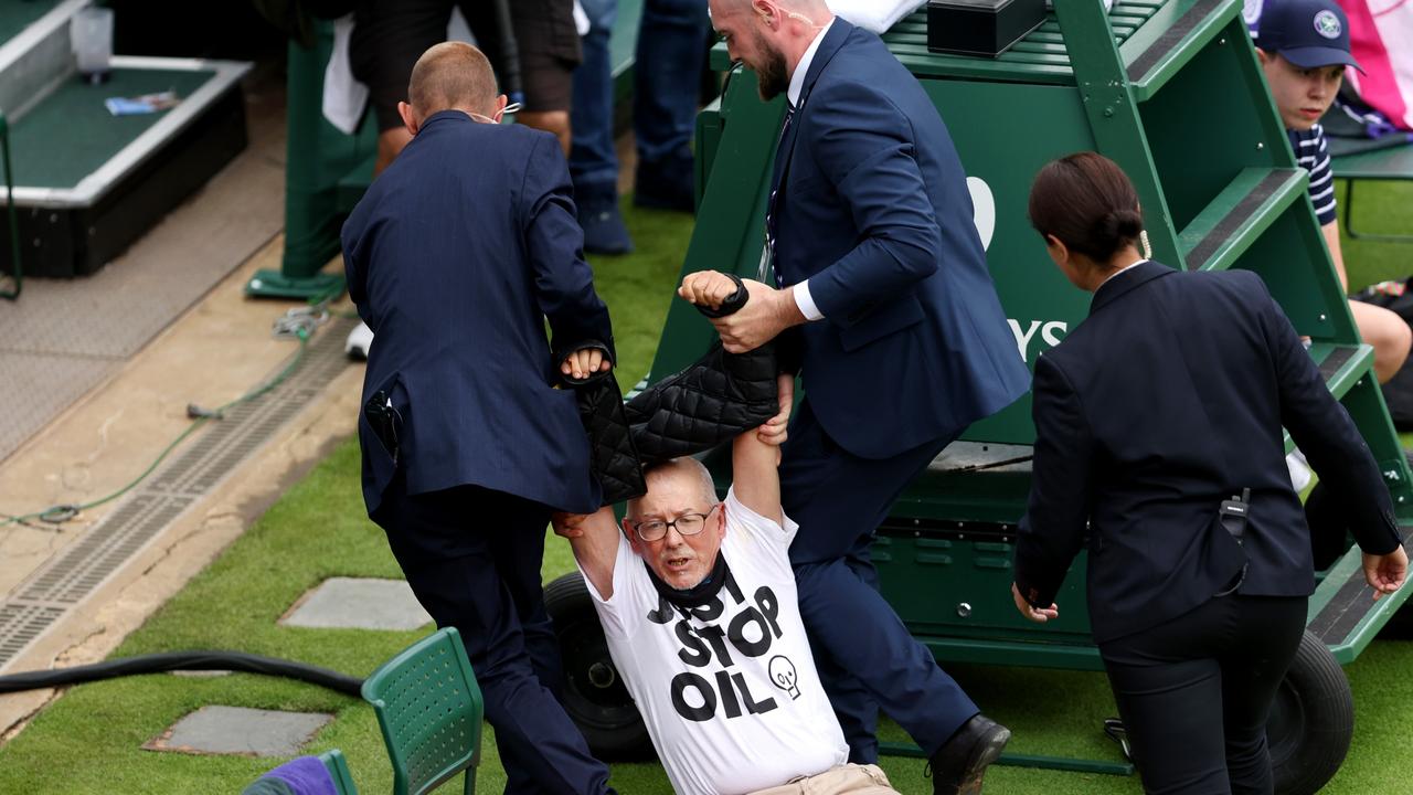 LONDON, ENGLAND – JULY 05: A protester is taken away by security on court 18 after a Just Stop Oil protest during the Women's Singles first round match between Katie Boulter of Great Britain and Daria Saville of Australia during day three of The Championships Wimbledon 2023 at All England Lawn Tennis and Croquet Club on July 05, 2023 in London, England. (Photo by Julian Finney/Getty Images)