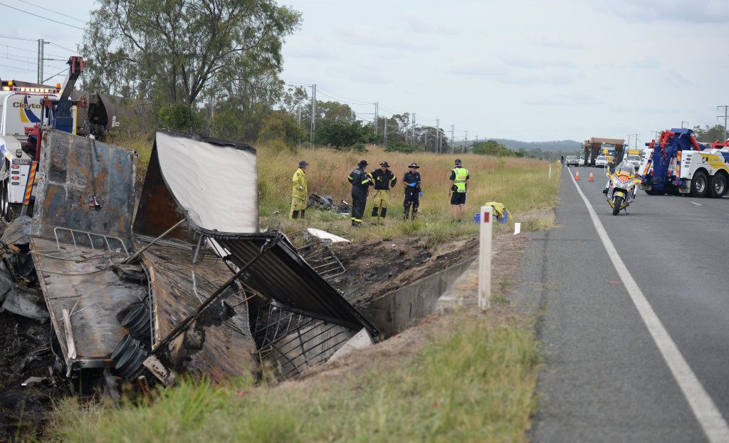 Traffic backs up as crews assess how to remove the vehicle from the culvert. Picture: Melanie Plane