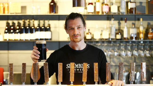 Shambles Brewery’s bar keep, Will Caught, serves up one of Tassie’s finest winter beers the aptly named big, smooth and velvety Barry White, which retails for $13 for a pint. Picture: MATT THOMPSON