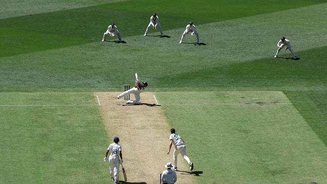 Rishabh Pant hits Pat Cummins for a six while falling to the ground. Picture: Getty