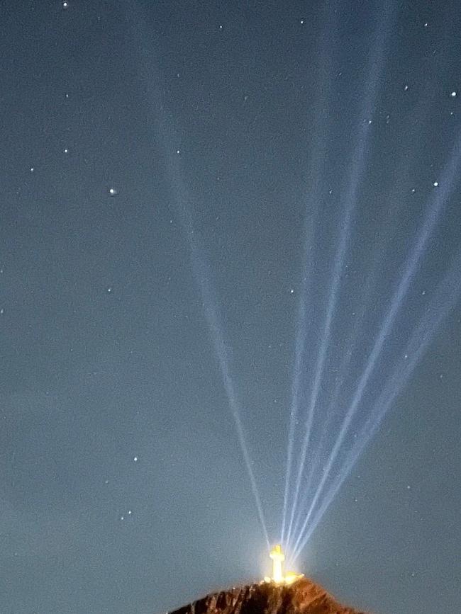 The 20m high cross atop Memory Mountain was first officially lit up on Good Friday, with hopes it will bring tourism and jobs to the area. Supplied.