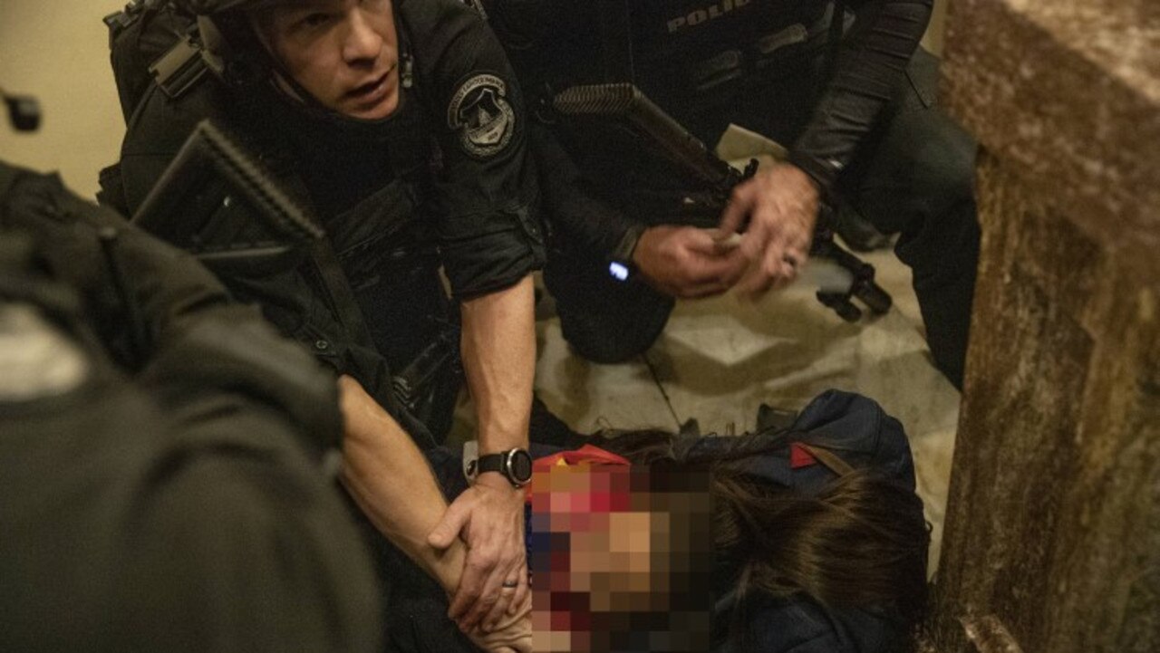 A person lies on the ground after being shot during a protest at the U.S. Capitol in Washington, D.C. Picture: Getty