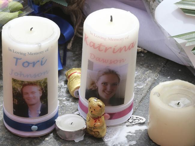 Candle tributes left for siege victims Tori Johnson and Katrina Dawson. Pic: AP/Rob Griffith