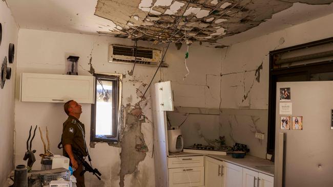 An Israeli soldier checks a house that was hit by a Hezbollah rocket in Kiryat Shmona in northern Israel near the Lebanon border. Picture: AFP.