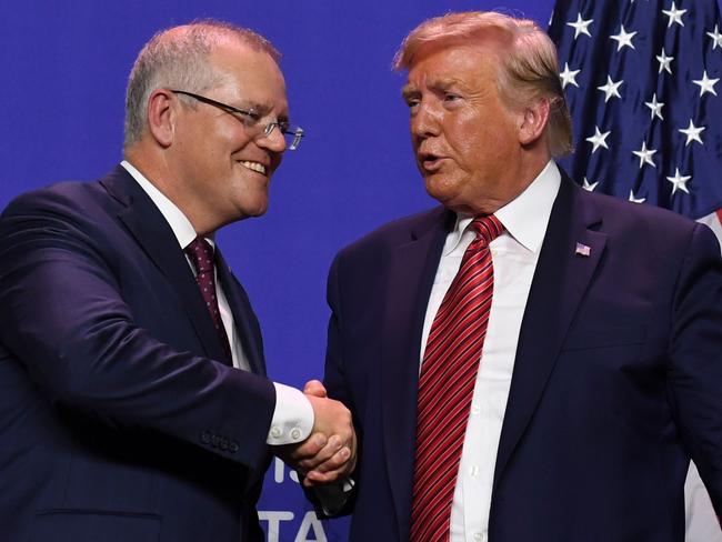 (FILES) In this file photo taken on September 22, 2019 US President Donald Trump and Australian Prime Minister Scott Morrison shake hands during a visit to Pratt Industries plant opening in Wapakoneta, Ohio. - Donald Trump asked Australia to "assist" in discrediting a Russia investigation that has clouded his presidency, with Prime Minister Scott Morrison admitting October 1, 2019 that he agreed to help.Several other calls and meetings between Trump and foreign leaders, including Russia's Vladimir Putin are now under scrutiny. Separately, the Washington Post reported that Attorney General Bill Barr has had multiple contacts with officials and spies in Australia, Britain and Italy in a bid to investigate Mueller and US intelligence findings. (Photo by SAUL LOEB / AFP)