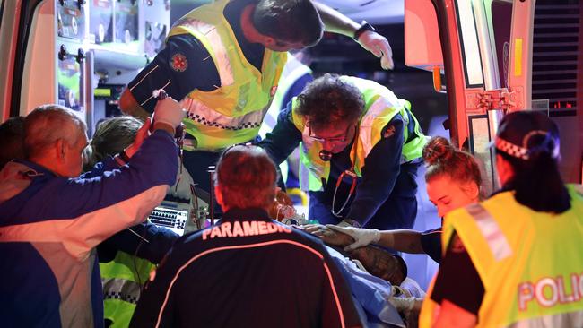 Paramedics work to save the man’s life. Photo by Richard Gosling