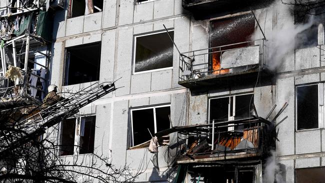 Firefighters work on a fire in a building after bombings on the eastern Ukraine town of Chuguiv. Picture: Aris Messinis / AFP