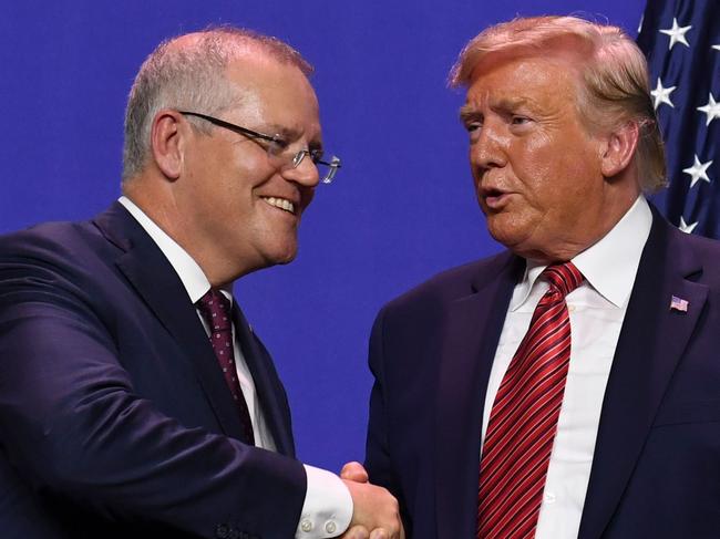 (FILES) In this file photo taken on September 22, 2019 US President Donald Trump and Australian Prime Minister Scott Morrison shake hands during a visit to Pratt Industries plant opening in Wapakoneta, Ohio. - Donald Trump asked Australia to "assist" in discrediting a Russia investigation that has clouded his presidency, with Prime Minister Scott Morrison admitting October 1, 2019 that he agreed to help.Several other calls and meetings between Trump and foreign leaders, including Russia's Vladimir Putin are now under scrutiny. Separately, the Washington Post reported that Attorney General Bill Barr has had multiple contacts with officials and spies in Australia, Britain and Italy in a bid to investigate Mueller and US intelligence findings. (Photo by SAUL LOEB / AFP)