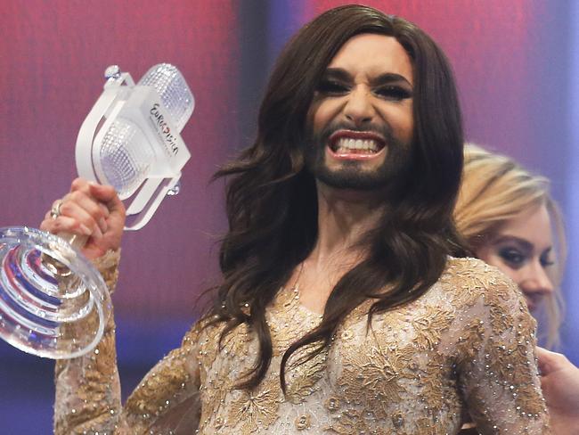Singer Conchita Wurst representing Austria who performed the song 'Rise Like a Phoenix' celebrates with the trophy after winning the Eurovision Song Contest in the B&W Halls in Copenhagen, Denmark, Saturday, May 10, 2014.(AP Photo/Frank Augstein)