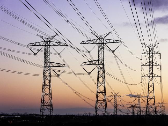 Electricity pylons during dusk evening sky sunset. Energy generic