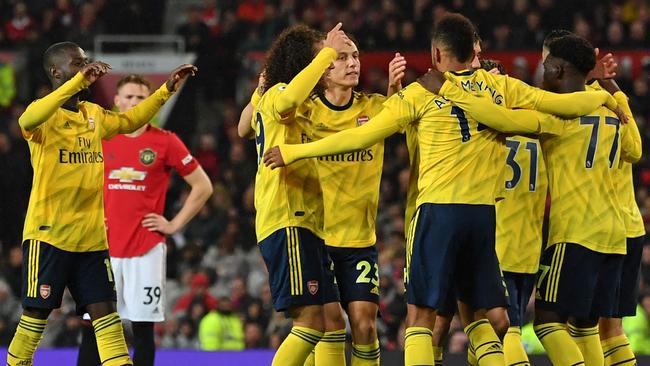 Arsenal’s Gabonese striker Pierre-Emerick Aubameyang (centre right) celebrates with teammates after scoring against Manchester United at Old Trafford. Picture: AFP