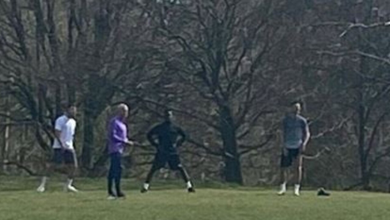Jose Mourinho captured running a training session with three players.