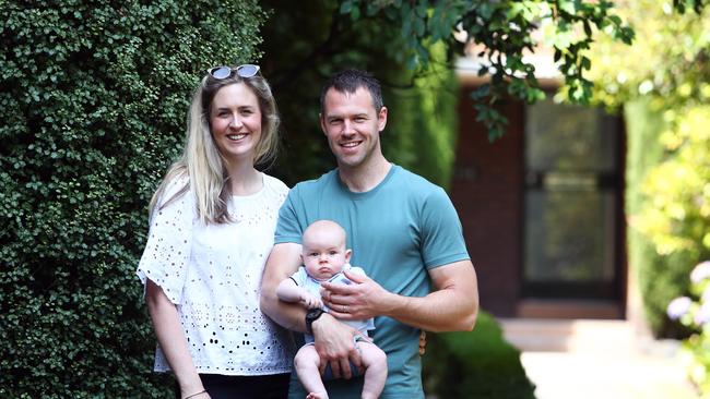 Sam Playfair with his wife Liz Franklyn and their 3-month-old son Ollie at their two-bedroom art-deco flat in Melbourne. Picture: Aaron Francis