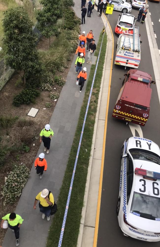 Building site workers leaving the scene after the incident. Picture: Stephanie Bedo