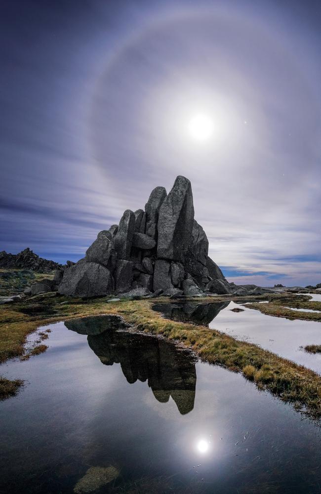 A full moon alongside the planet Mars shining through cirrostratus clouds over Kosciuszko National Park. Picture: Luke Tscharke