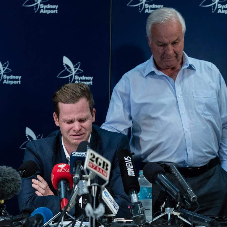 An emotional Steve Smith is comforted by his father Peter as he fronts the media at Sydney International Airport following investigations into the ball tampering in South Africa. Picture: Brook Mitchell/Getty Images