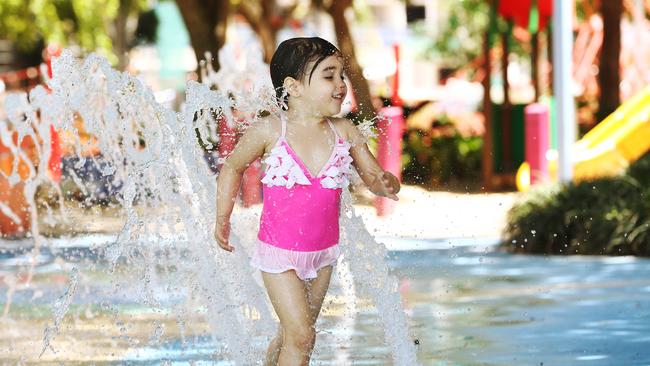 Milla Lucht cools down by running through the water fountains at Muddy’s Playground on the Cairns Esplanade. Picture: Brendan Radke