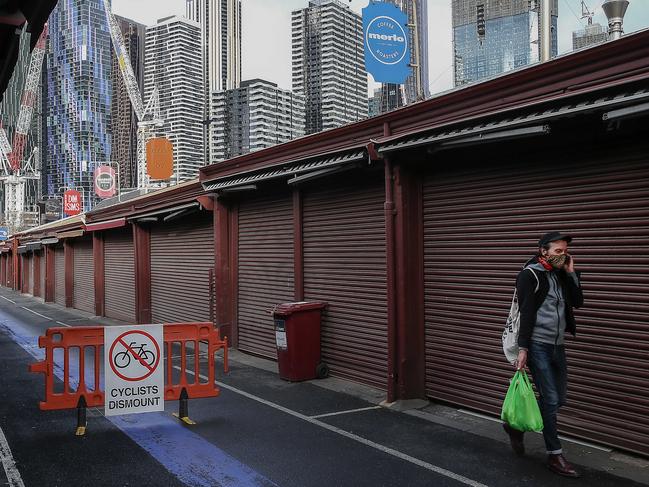 The effects of a stage 4 lockdown are evident as the streets of Melbourne's CBD resemble at times a ghost town. A man walking in a vacant Queen Victoria Market.  Picture : Ian Currie