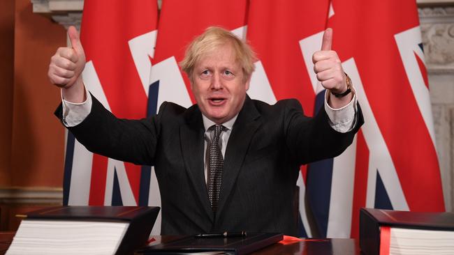 Prime Minister, Boris Johnson gives a thumbs up gesture after signing the Brexit trade deal with the EU in number 10 Downing Street.