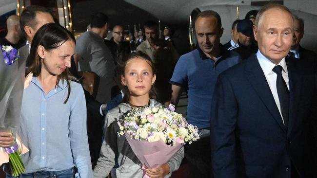 President Vladimir Putin was on the tarmac to welcome back the Dultsevs: Anna, left, Sofia and her father Artyom, second right. Picture: by Mikhail Voskresenskiy/POOL / AFP