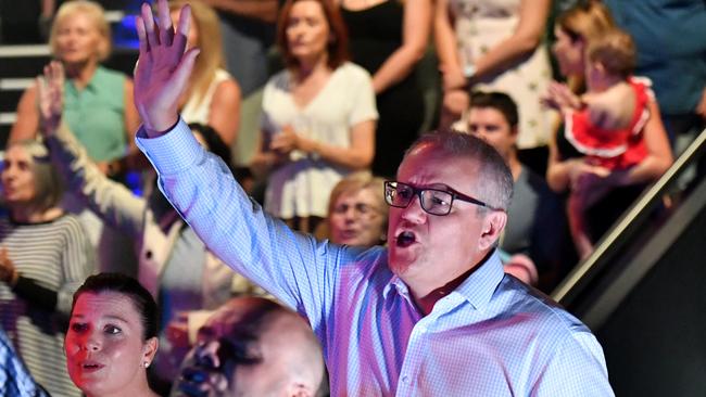 Prime Minister Scott Morrison and wife Jenny sing during an Easter Sunday service at his Horizon Church at Sutherland in Sydney, Sunday, April 21, 2019. (AAP Image/Mick Tsikas) NO ARCHIVING