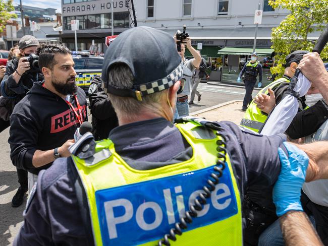 Avi Yemeni clash with protesters. Anti Fascist protesters mach through Carlton.NOT PICTURED:  Freedom Rally Protesters gather at the Victorian State Parliament in Melbournes CBD to protest Covid vaccine mandates the new pandemic Bill and various other causes. Large numbers of police at the rally. Picture: Jason Edwards