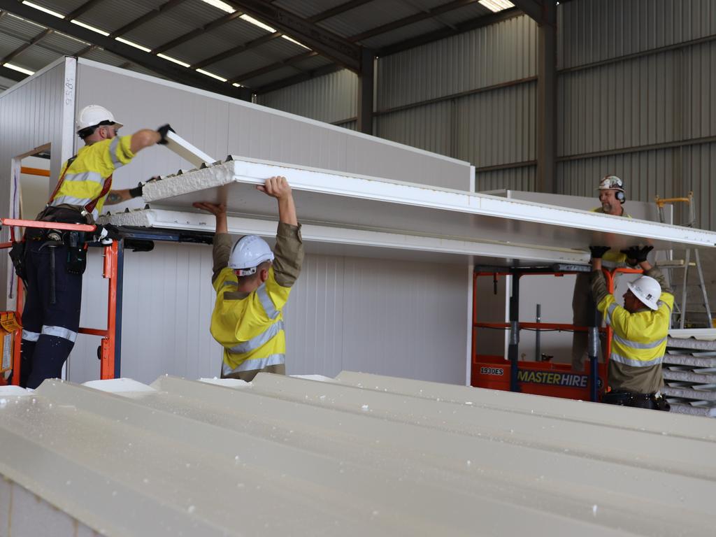 Carpenters with Hutchinson Builders putting together one of the modules that will form a majority of the accommodation facilities for the Wellcamp quarantine hub.