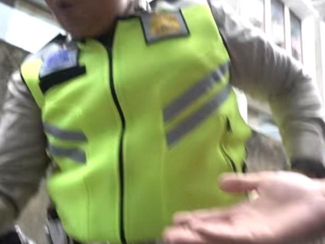 The officer is seen briefly in the clip.