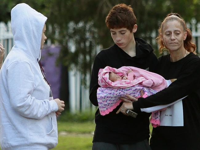 Jenifer Morrison and Jayden Lavender with baby Aria and his mother, Tracy, after they were happily found safe and well after skipping hospital. Picture: Justin Sanson