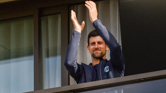 Men’s tennis world number one Novak Djokovic is seen on his balcony while in hotel quarantine in Adelaide. Picture: AFP