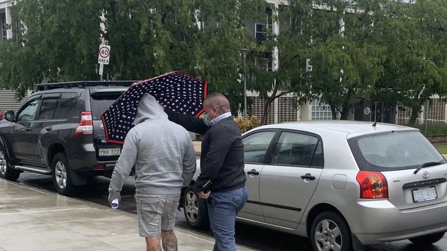 John Wright leaves ACT Magistrates Court accompanied by an associate. Picture: Julia Kanapathippillai