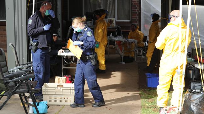 Drug and Organised Crime Task Force detectives begin dismantling the lab. Picture: Tait Schmaal