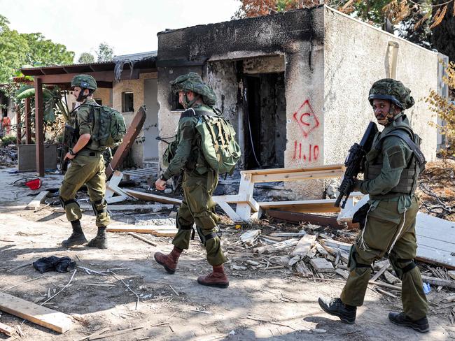 Israeli soldiers patrol in kibbutz Kfar Aza in southern Israel, where Hamas fighters killed 100 people including children on October 7. Picture: AFP