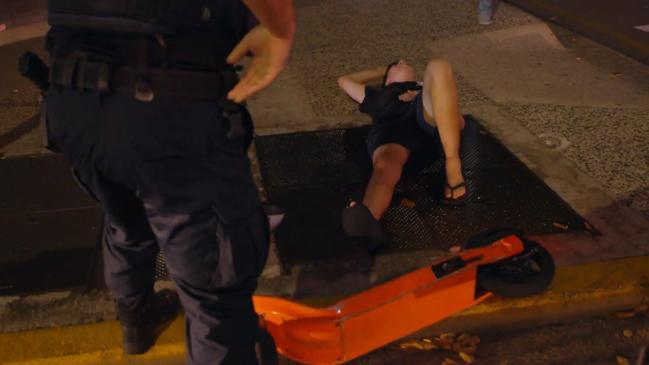 Police help a man who hit a ‘notorious’ kerb at the intersection of Smith and Knuckey Streets. Picture: Network Ten