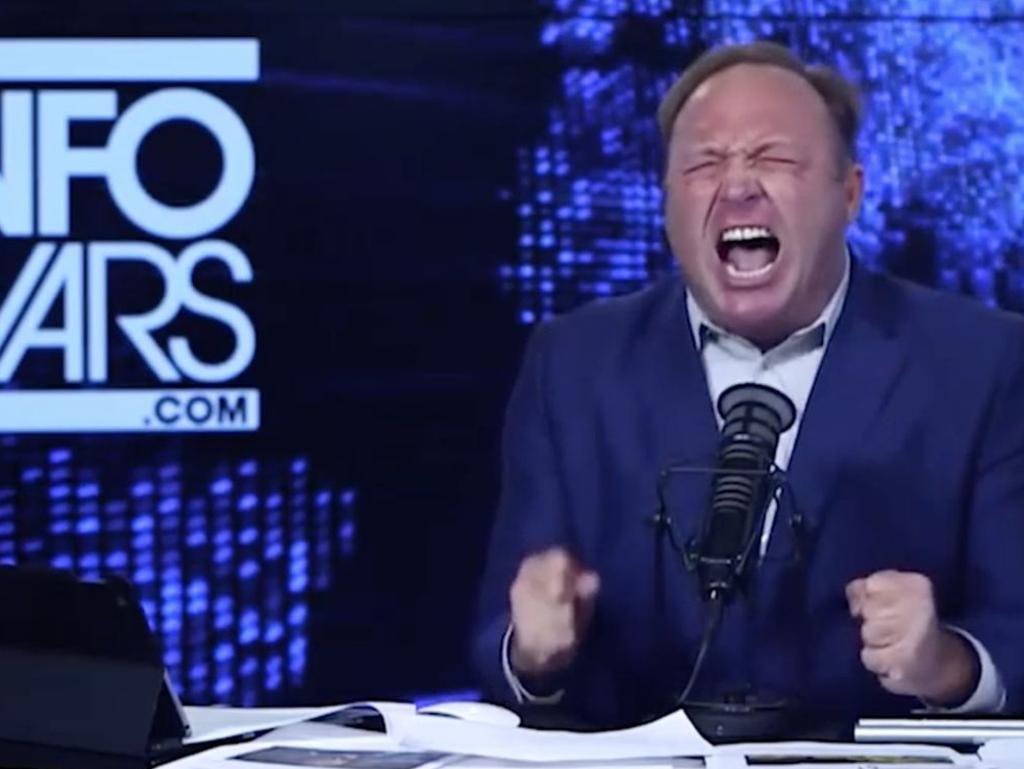 Alex Jones in full flight at the desk of his InfoWars program.