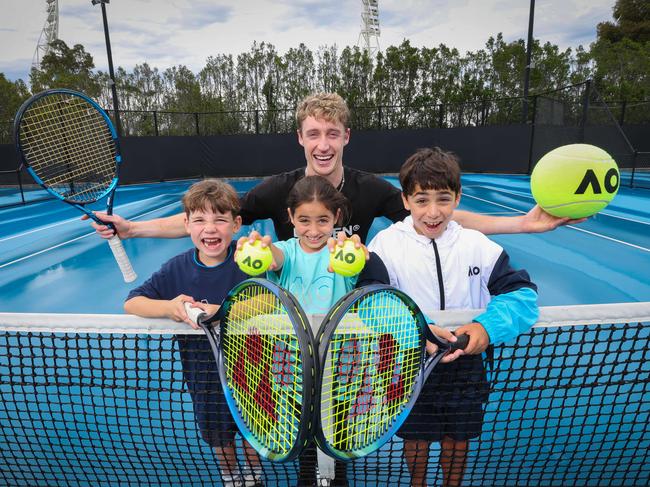 AO Opening Week, presented by the Herald Sun, will take place from January 6-11. Pictured are Aussie player Marc Polmans with juniors Hamish, 6, Isabelle, 8, and Thomas, 10. Picture: David Caird