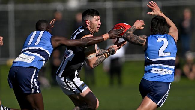 WRFL: Point Cook Centrals’ Kwar Ater and Corey Vandermeer close in on Nathan Montague of Parkside. Picture: Andy Brownbill