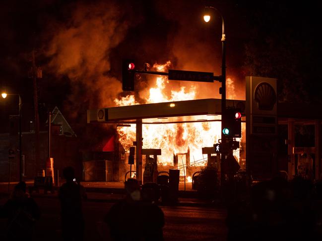 A fire burns at a gas station on Lake Street in Minneapolis, Minnesota. Picture: Getty