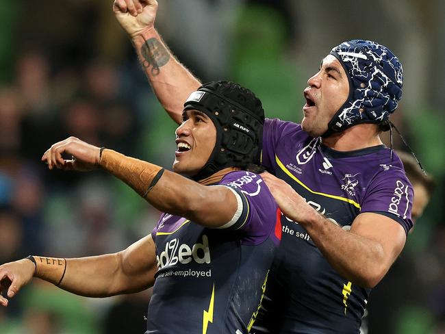 MELBOURNE, AUSTRALIA - JULY 20: Sualauvi Faalogo of the Storm celebrates scoring a try with Jahrome Hughes of the Storm during the round 20 NRL match between Melbourne Storm and Sydney Roosters at AAMI Park, on July 20, 2024, in Melbourne, Australia. (Photo by Kelly Defina/Getty Images)