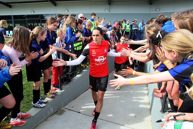 <p>Fans high five Western Sydney Wanderers players as they come onto the field for their A League match against Melbourne Victory at Twin Ovals, Kingston. Picture: Kim Eiszele</p>