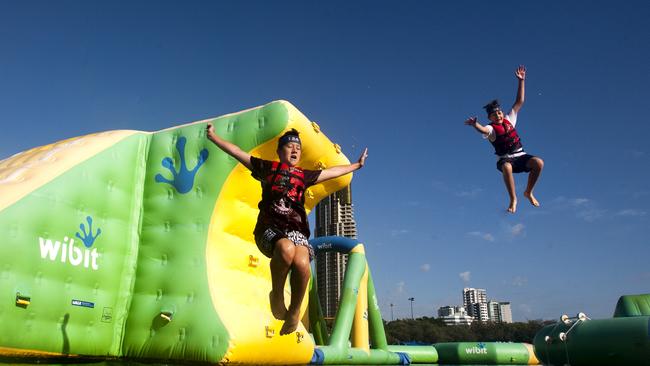 Ryan Downey and Oscar Mackay jumping into the Broadwater at the Aquasplash