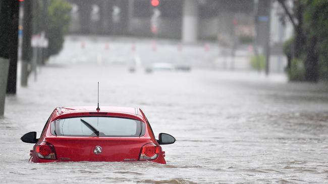 A submerged car at Northey St on Saturday. Picture: John Gass